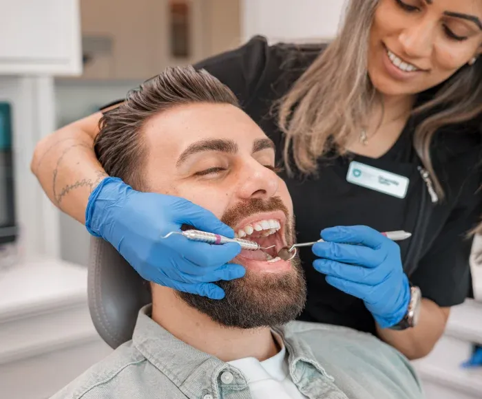 Dentist performing a thorough dental exam at Royale Dental
